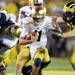 Notre Dame quarterback Tommy Rees attempts to hold off defensive end Brennen Beyer before he is sacked during the second half at Michigan Stadium on Saturday, September 7, 2013. Melanie Maxwell | AnnArbor.com